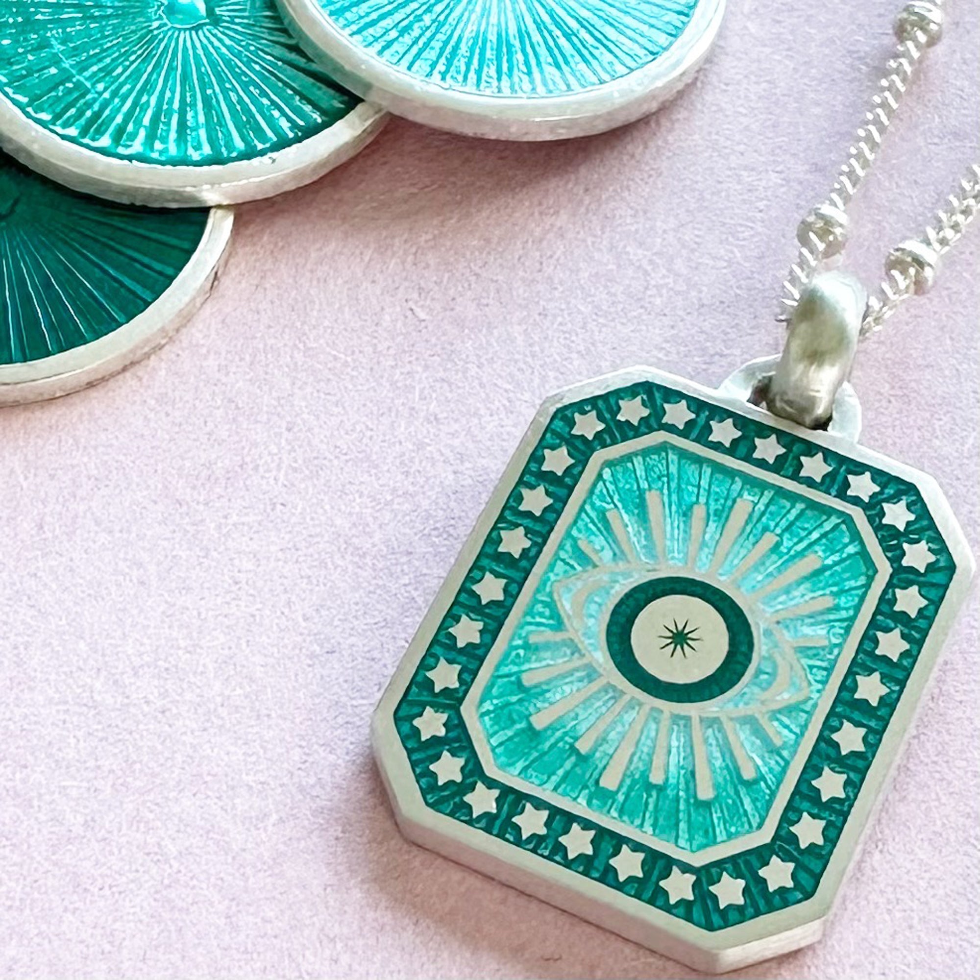 Vitreous Enamel Evil Eye Necklace by Sally Clay Jewellery close up with enamel colours
