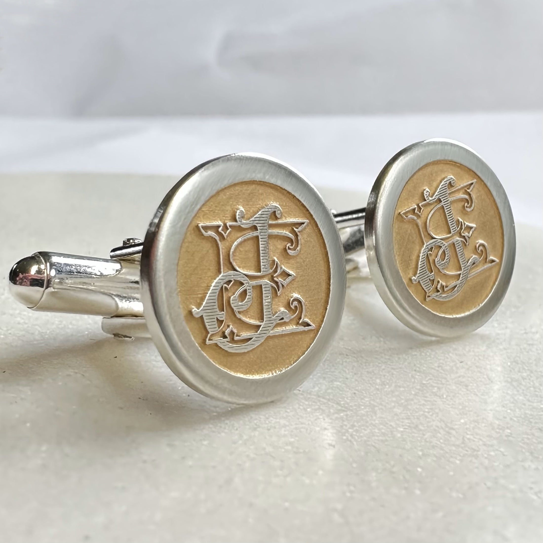 Wedding logo custom cufflinks made from sterling silver with gold highlighting showing both fronts by Sally Clay Jewellery