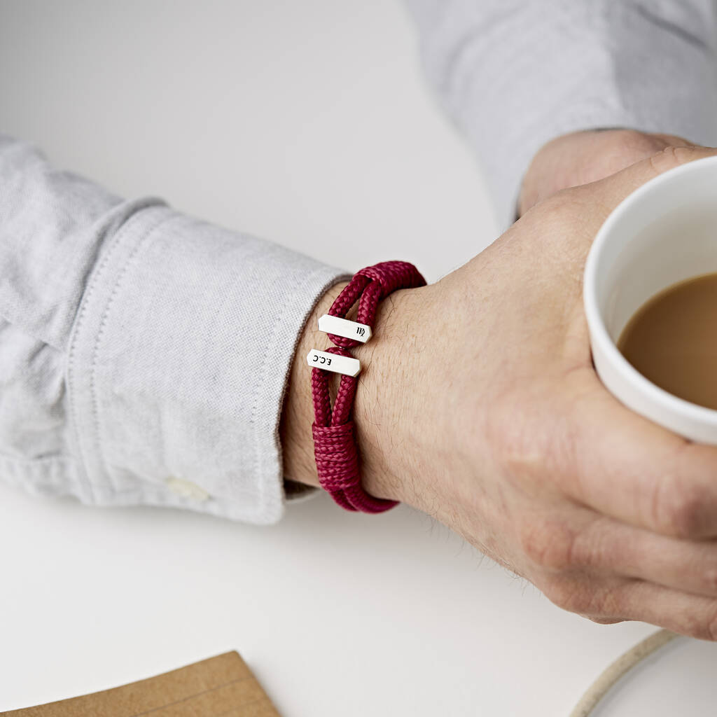 men's personalised sterling silver and red cord bracelet personalised with an infinity sign and initials by Sally Clay Jewellery on a man's wrist