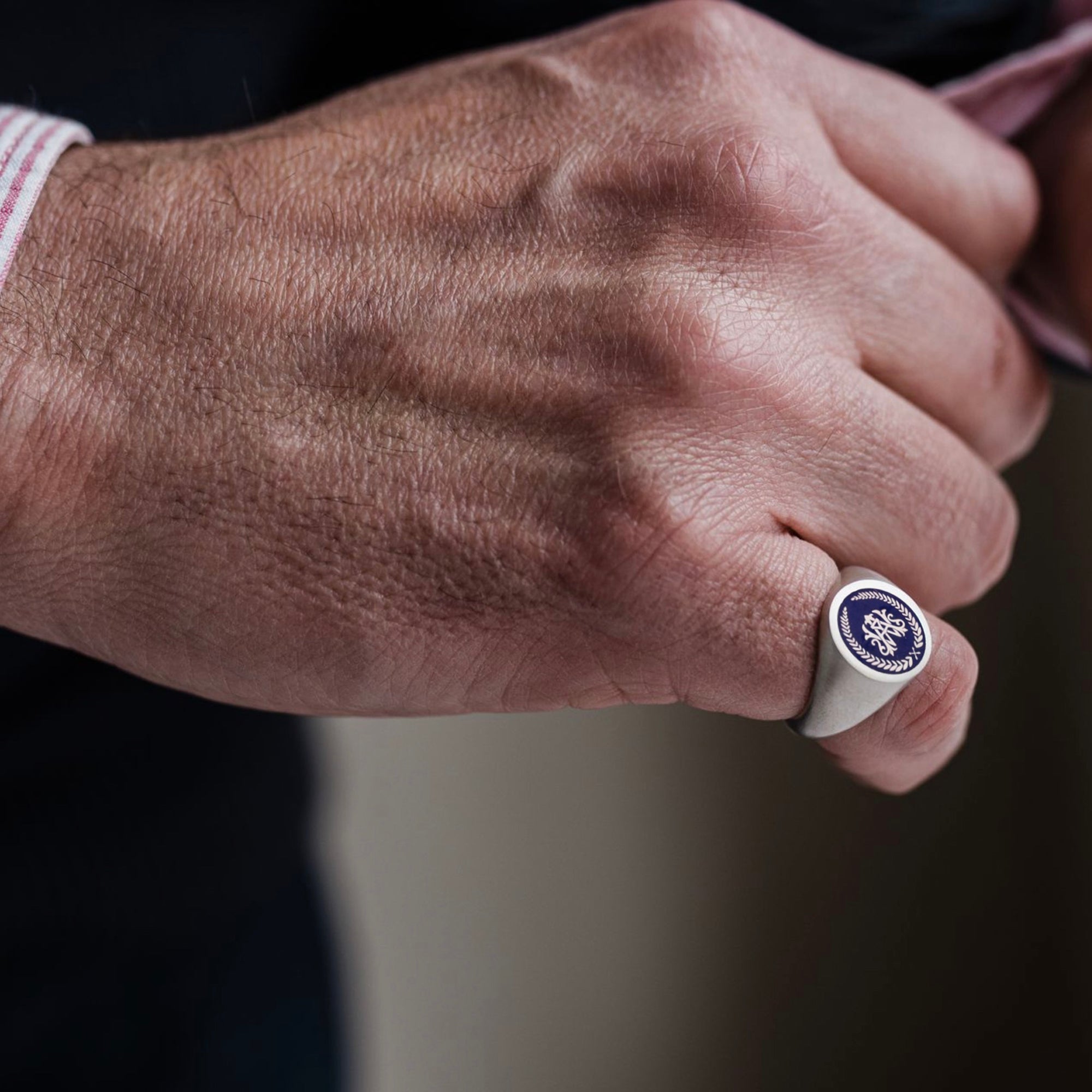 Entwined Monogram and wreath signet ring on hand