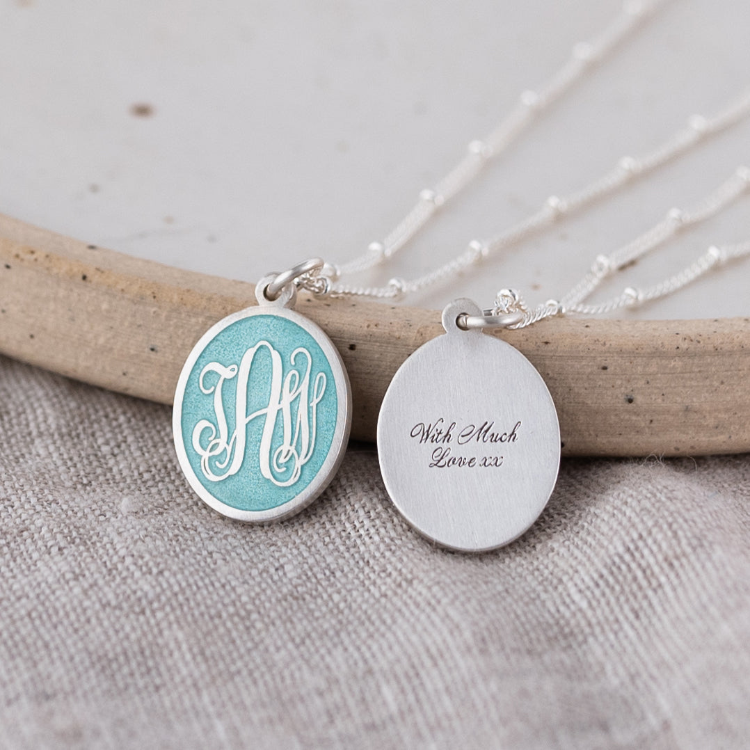 Three Initial Monogram Aquamarine Enamel Pendant necklace on Linen front and back separately