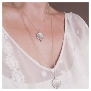 2 Solid Silver necklaces worn on a woman's chest