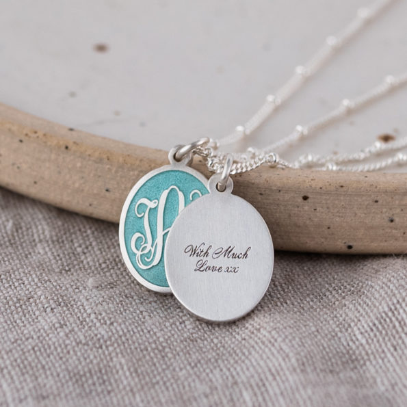 Three Initial Monogram Aquamarine Enamel Pendant necklace on Linen, front and back together