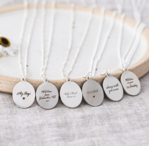 The backs of 6 pieces of engraved silver necklaces